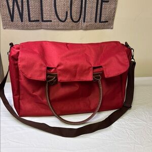 Red and Brown Travel Bag with Adjustable Strap and Sturdy Design